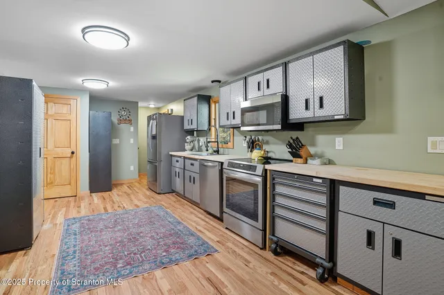 a kitchen with stainless steel appliances granite countertop a sink stove and cabinets