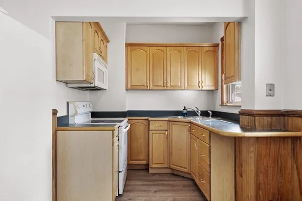 a kitchen with stainless steel appliances granite countertop a sink stove and cabinets