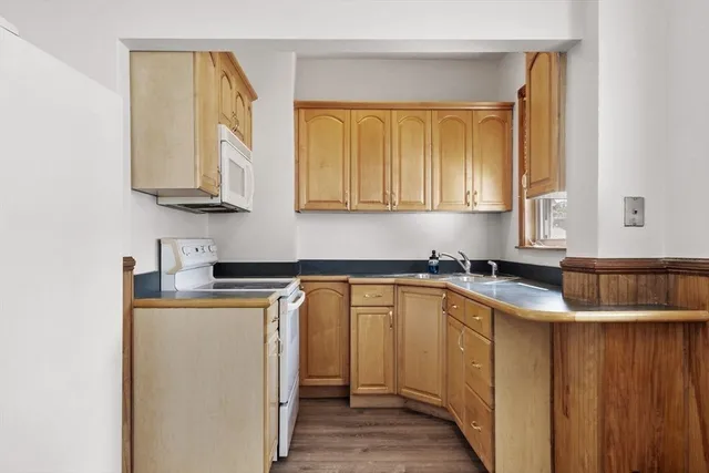 a kitchen with stainless steel appliances granite countertop a sink stove and cabinets