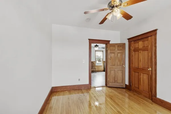 a view of empty room with wooden floor
