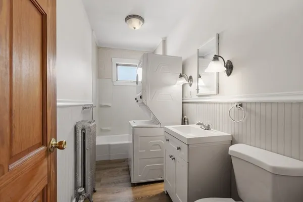 a bathroom with a toilet sink and mirror