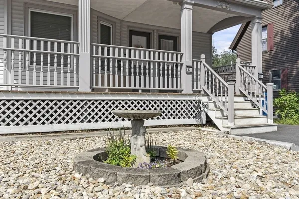 a view of a brick house with wooden fence