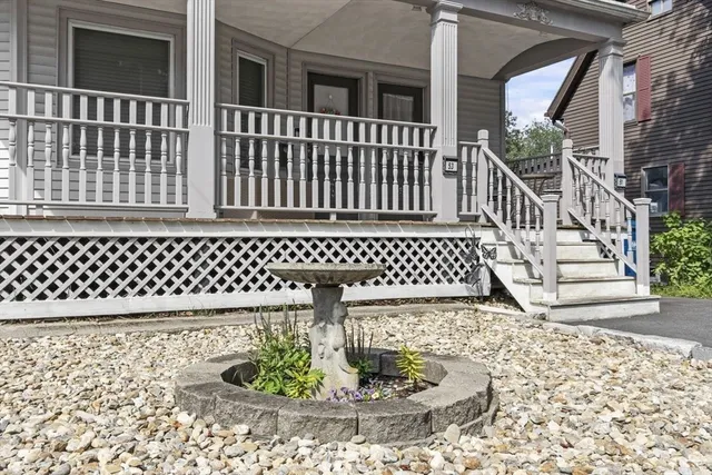a view of a brick house with wooden fence