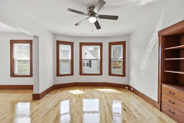 a view of an entryway with wooden floor and cabinet