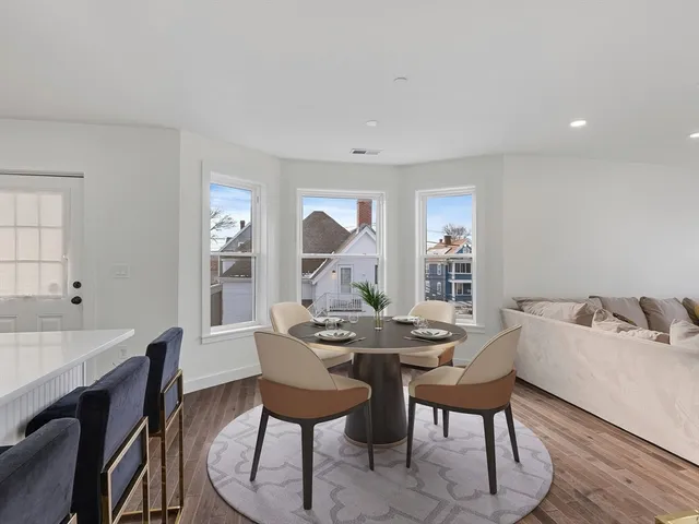 a big room with wooden floor and windows