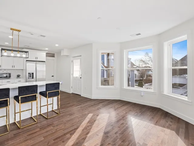 a living room with furniture and large window