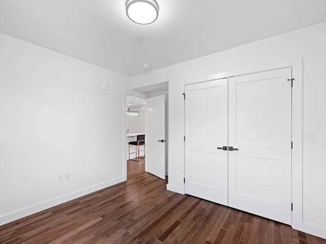 a bathroom with a granite countertop sink toilet mirror and bathtub