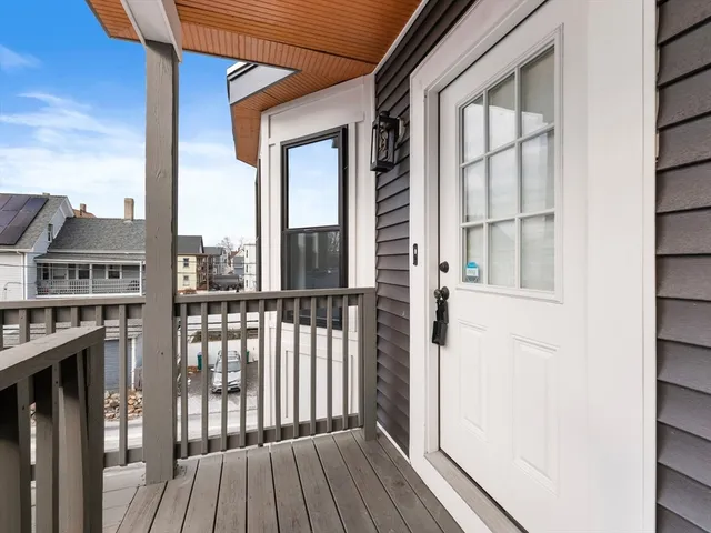 a view of a balcony with wooden floor and fence