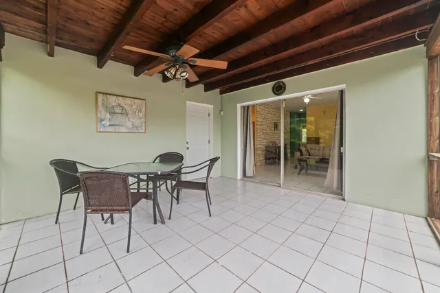 a dining room with furniture and a chandelier