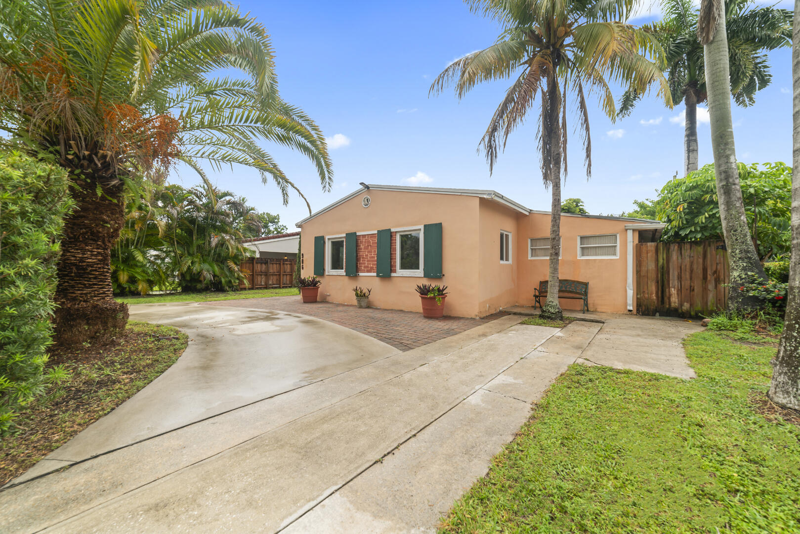 906 Northeast 5th Street Hallandale Beach, FL 33009 - Photo 2 of 35 a view of a house with a yard and palm trees