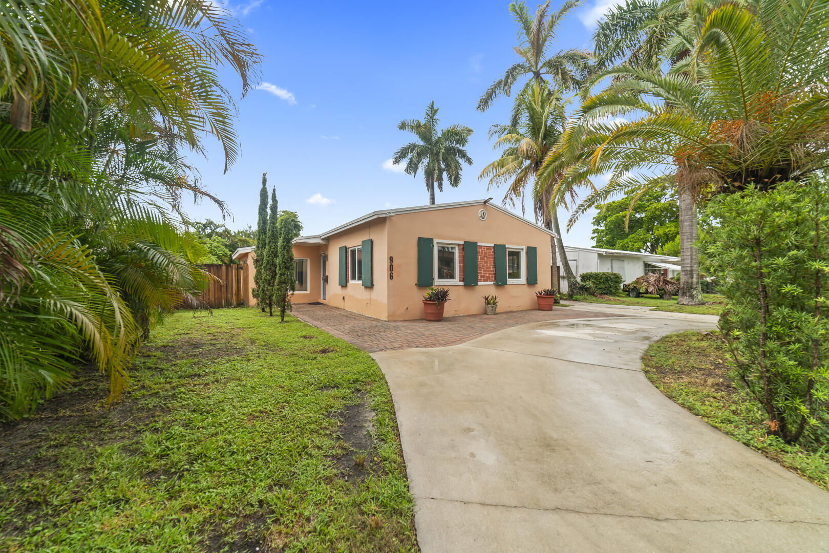 906 Northeast 5th Street Hallandale Beach, FL 33009 - Photo 25 of 35 a front view of a house with a yard