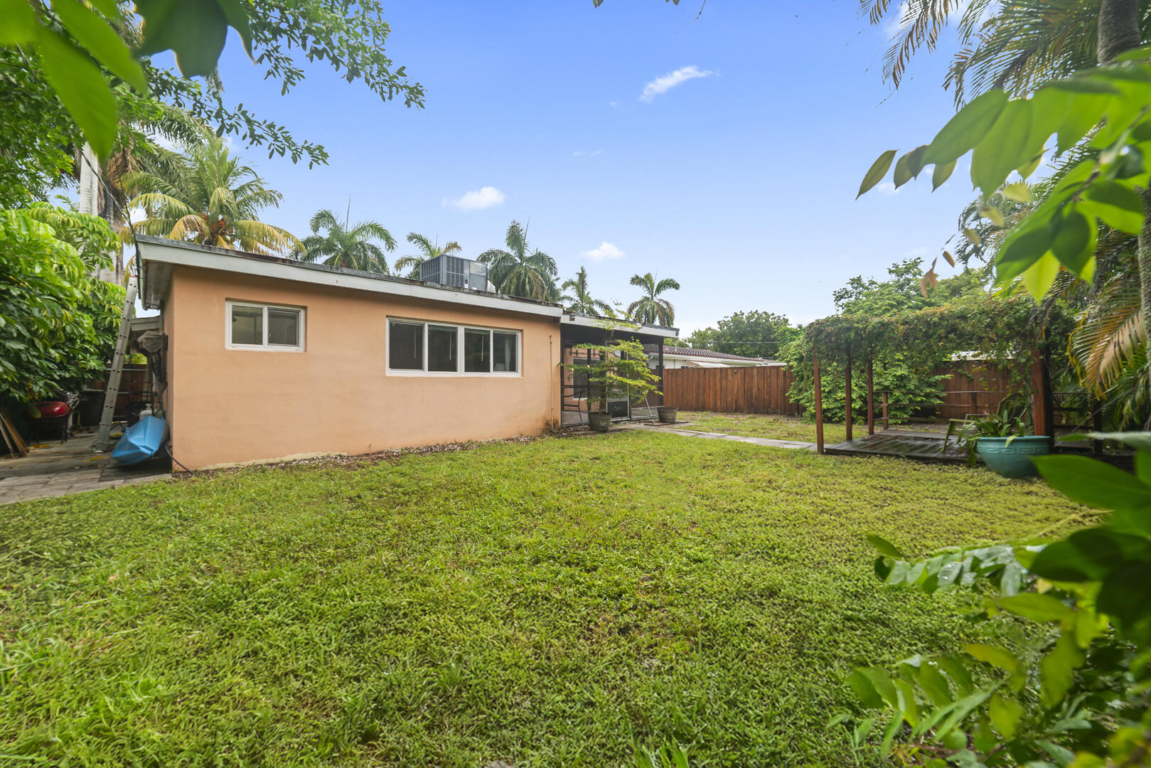 906 Northeast 5th Street Hallandale Beach, FL 33009 - Photo 29 of 35 a front view of house with yard and trees