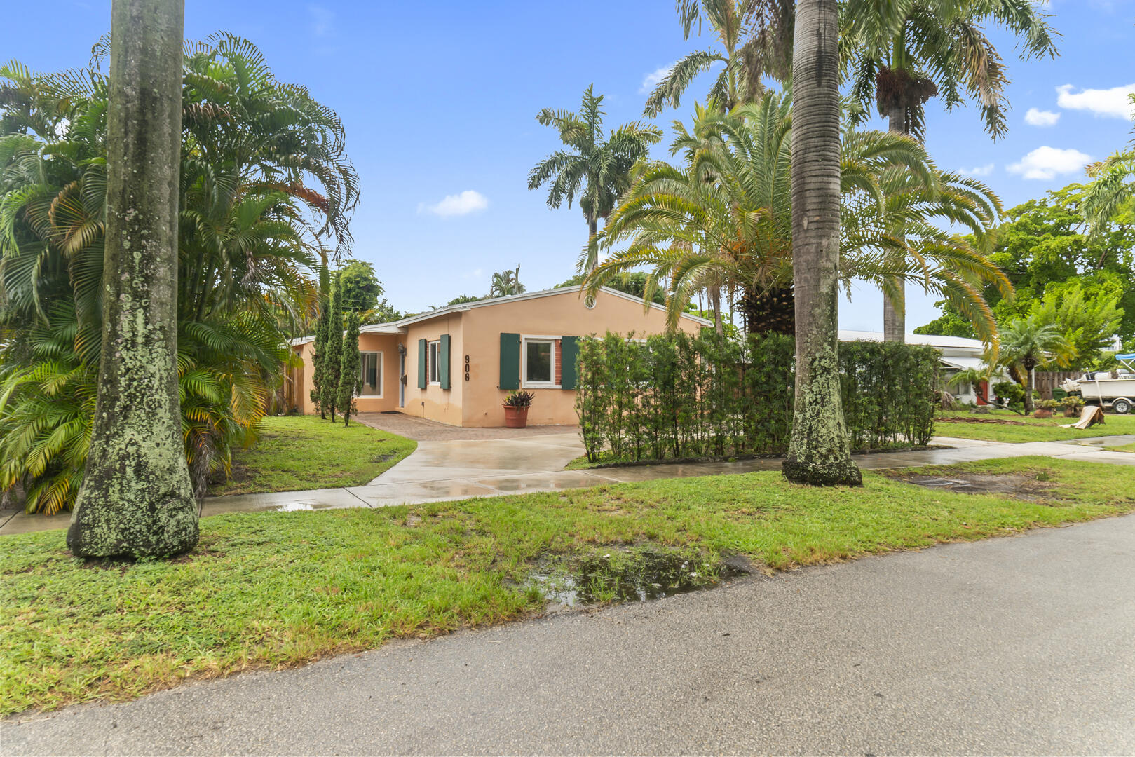 906 Northeast 5th Street Hallandale Beach, FL 33009 - Photo 34 of 35 a front view of a house with yard and green space