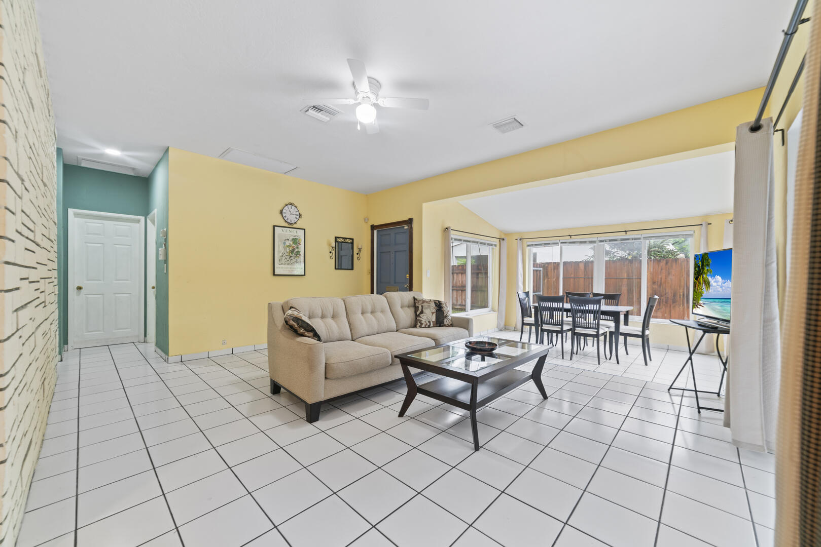 906 Northeast 5th Street Hallandale Beach, FL 33009 - Photo 8 of 35 a living room with furniture and a chandelier