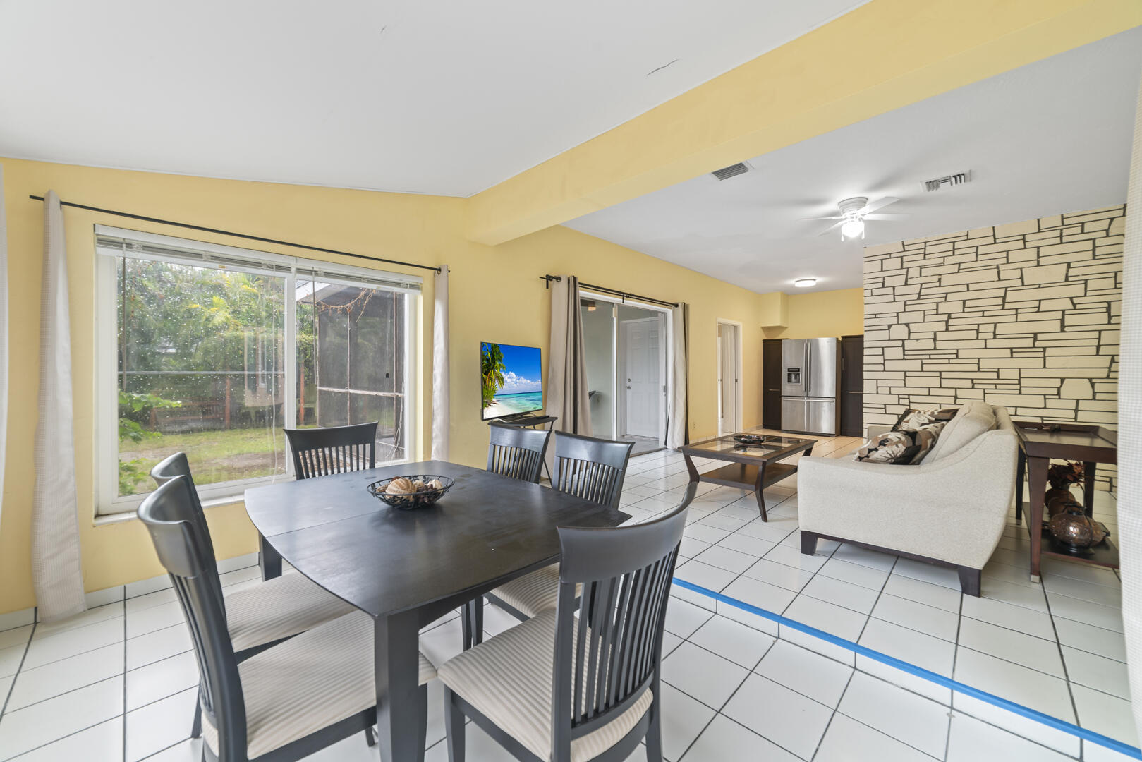 906 Northeast 5th Street Hallandale Beach, FL 33009 - Photo 9 of 35 a view of a dining room with furniture and wooden floor