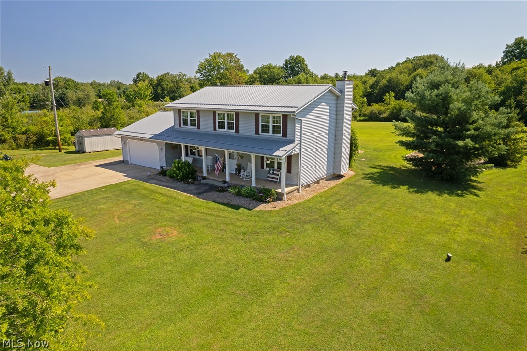 3856 Jones Road Diamond, OH 44412 - Photo 2 of 38 View of front of house with a porch, a garage, and a front lawn