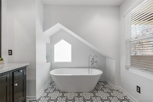 a spacious bathroom with a bathtub and a window