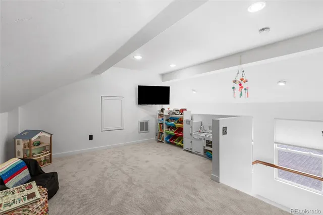 a view of a livingroom with workspace and a window