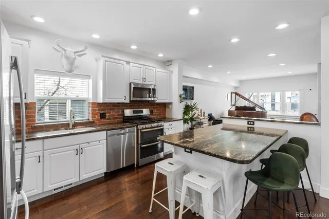 a kitchen with kitchen island granite countertop a sink and counter space