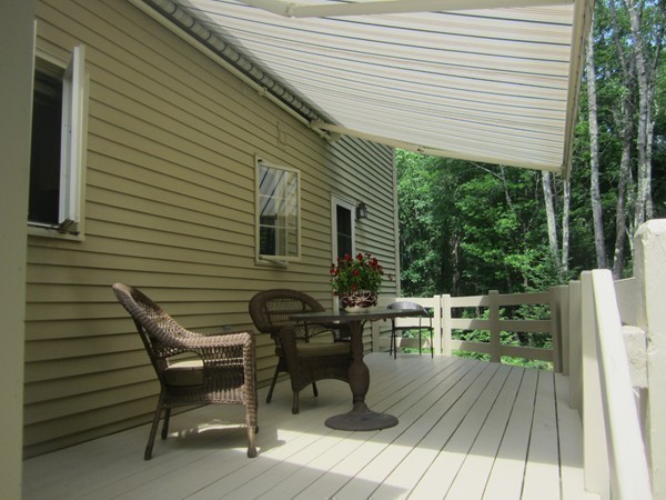 286 Sargent Road Boxborough, MA 01719 - Photo 16 of 29 a view of a patio with table and chairs with wooden floor and fence