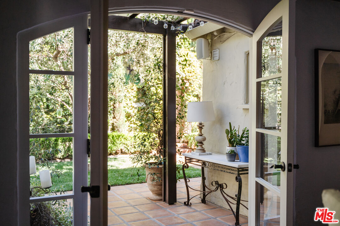 8430 Cresthill Road Los Angeles, CA 90069 - Photo 17 of 36 a view of a room that has a large window and wooden floor