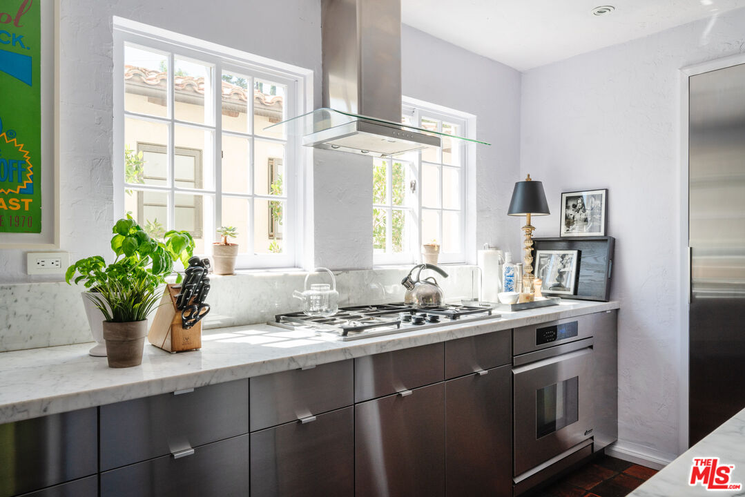8430 Cresthill Road Los Angeles, CA 90069 - Photo 18 of 36 a kitchen with a sink a window and potted plant
