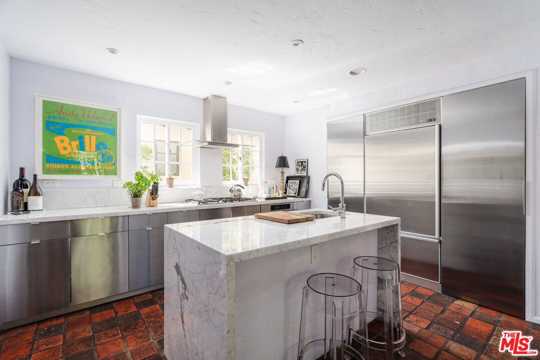 8430 Cresthill Road Los Angeles, CA 90069 - Photo 19 of 36 a kitchen with stainless steel appliances granite countertop a sink a stove and a refrigerator