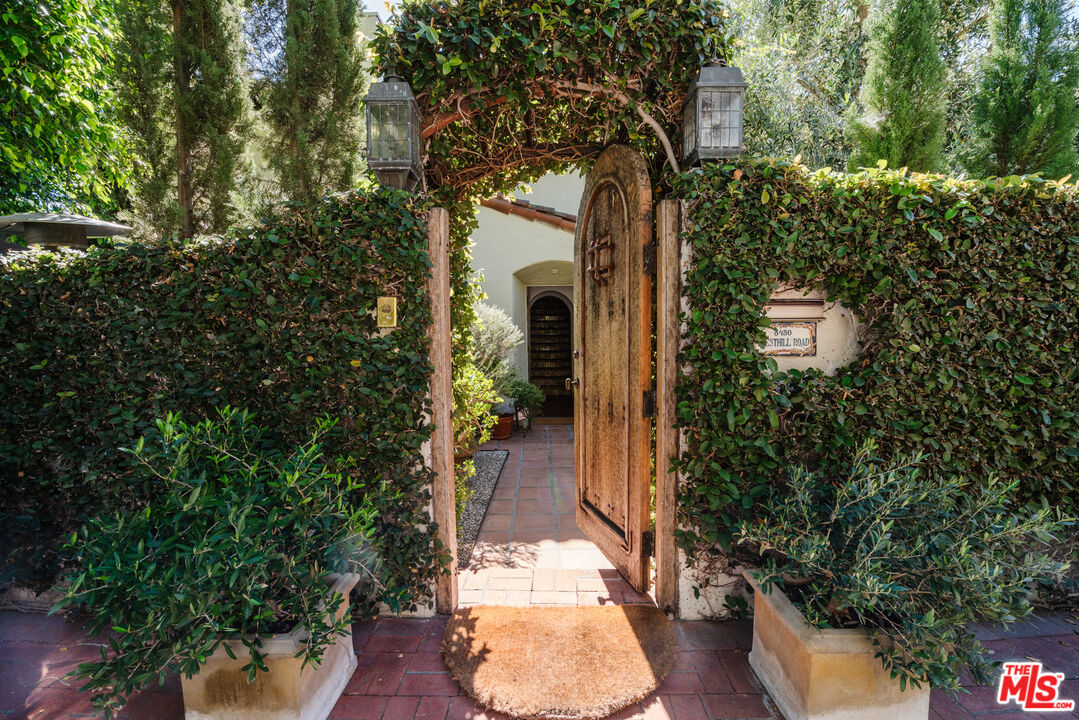8430 Cresthill Road Los Angeles, CA 90069 - Photo 2 of 36 view of a house with a yard