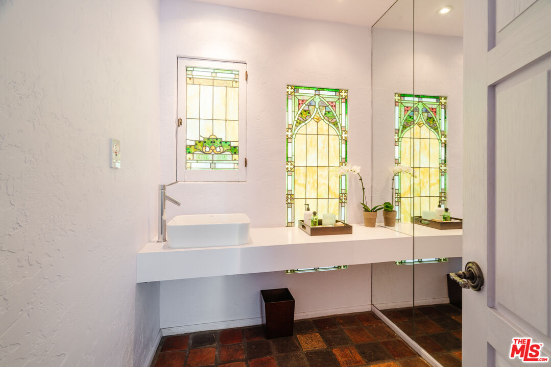 8430 Cresthill Road Los Angeles, CA 90069 - Photo 21 of 36 a room with a window and a chair