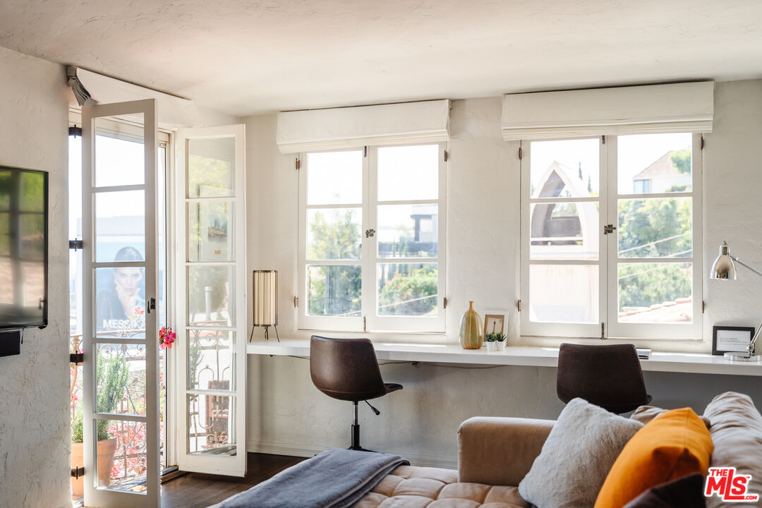8430 Cresthill Road Los Angeles, CA 90069 - Photo 23 of 36 a living room filled with furniture and a large window