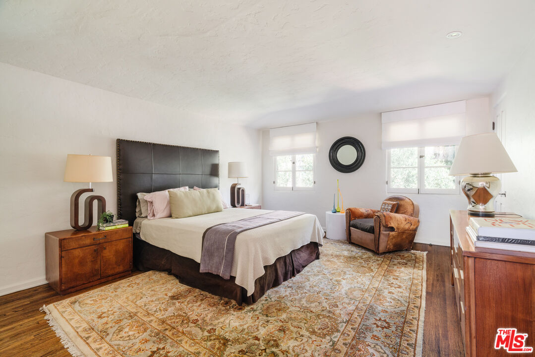 8430 Cresthill Road Los Angeles, CA 90069 - Photo 28 of 36 a bedroom with bed and a large window