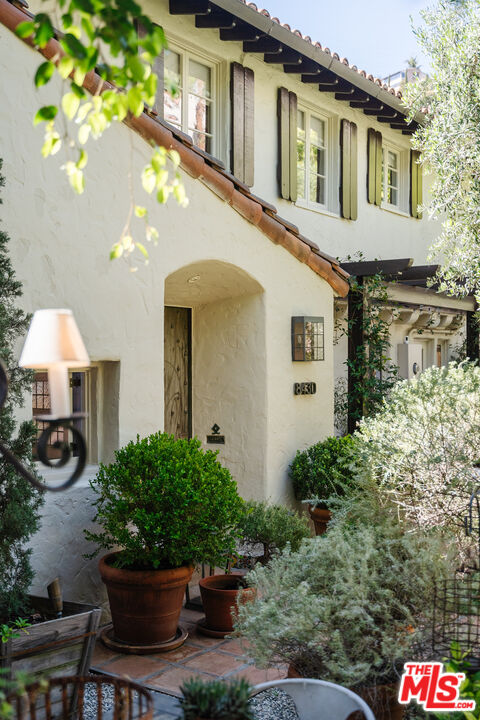 8430 Cresthill Road Los Angeles, CA 90069 - Photo 3 of 36 a front view of a house with patio
