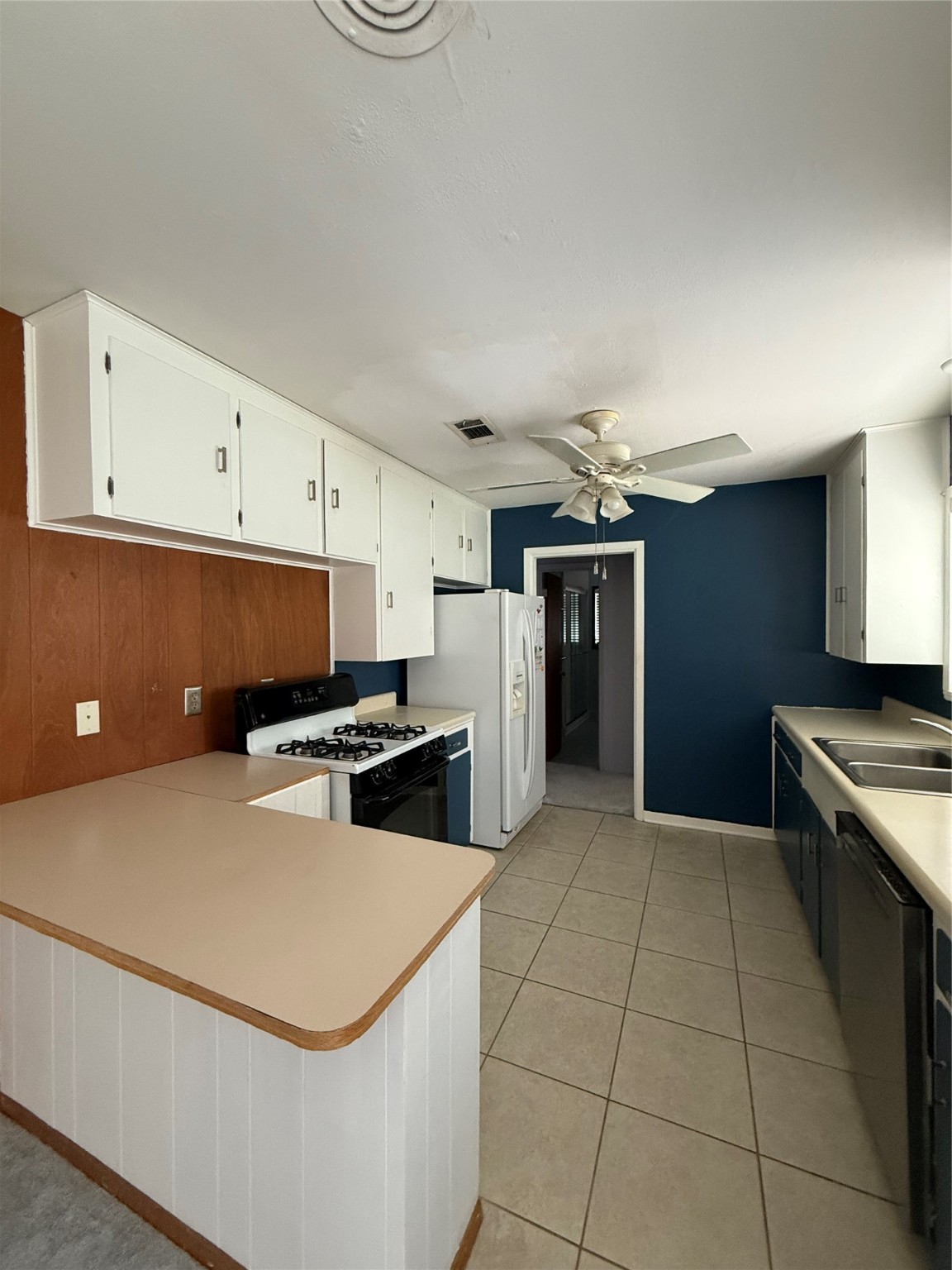 7945 Cedel Drive Houston, TX 77055 - Photo 11 of 11 a kitchen with stainless steel appliances a stove a sink and a refrigerator
