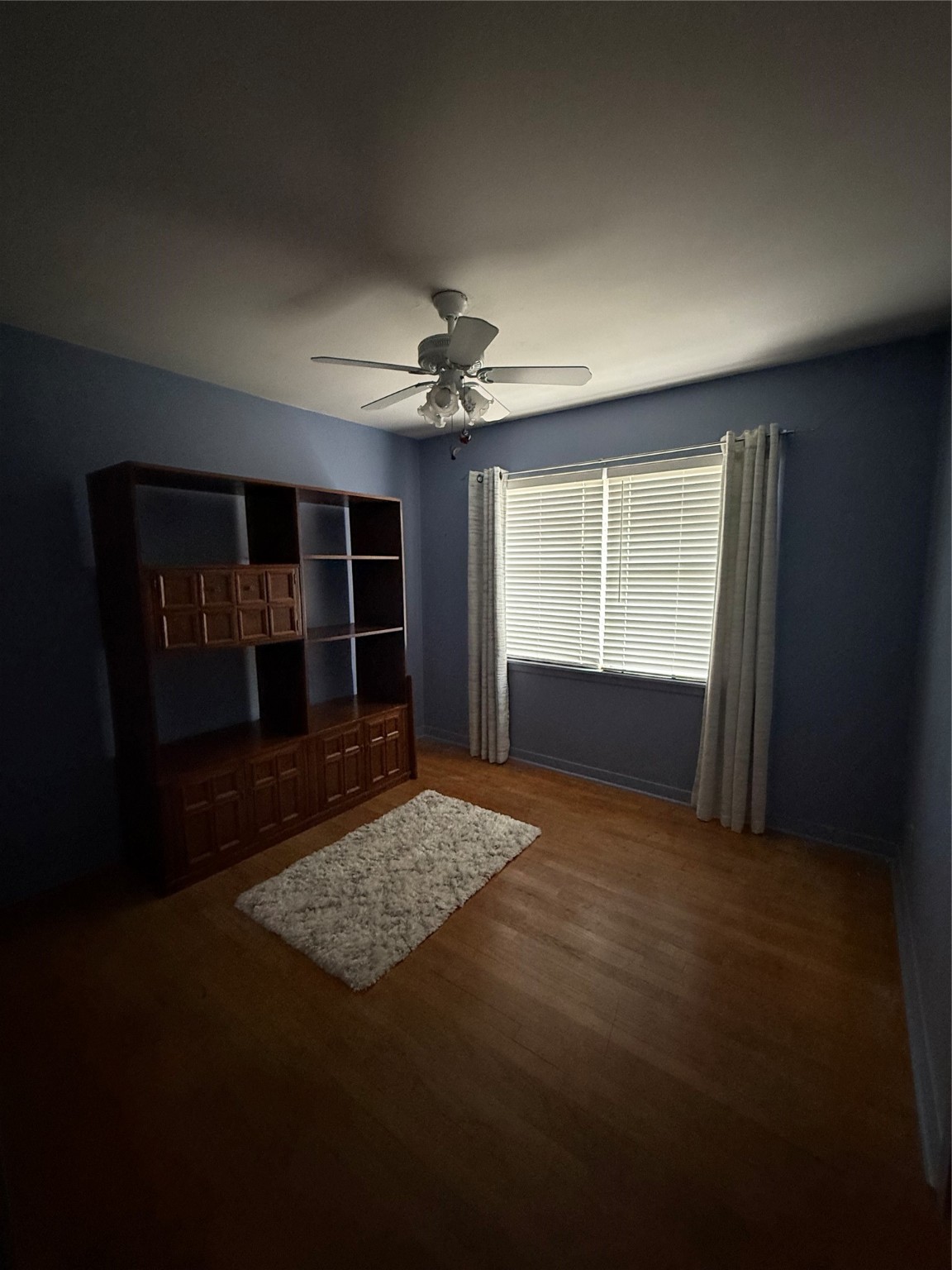 7945 Cedel Drive Houston, TX 77055 - Photo 9 of 11 a view of empty room with a fireplace and fan
