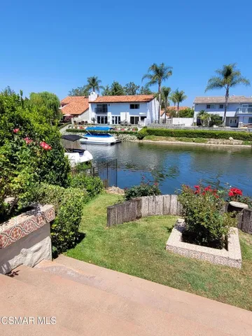 a view of a lake with a house swimming pool and outdoor space