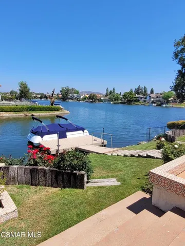 a view of a lake with houses in the back