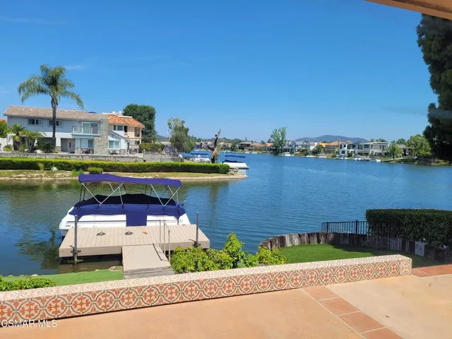 a swimming pool with outdoor seating and barbeque oven