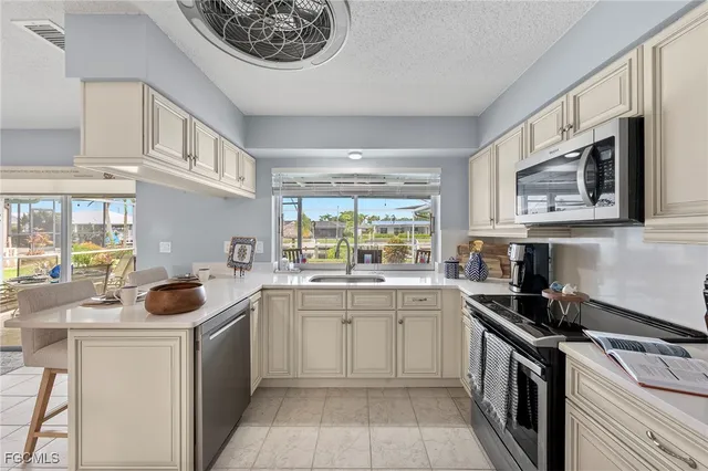 a kitchen with a sink dishwasher a stove and a refrigerator with wooden floor