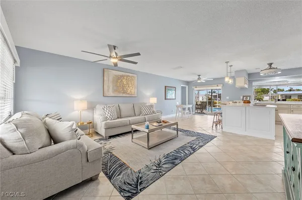 a living room with furniture and kitchen view