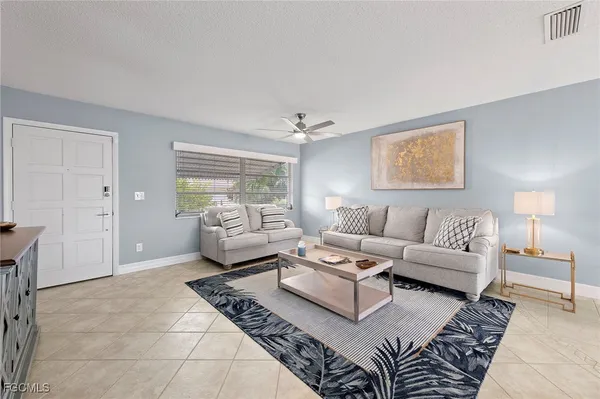 a living room with furniture and a rug