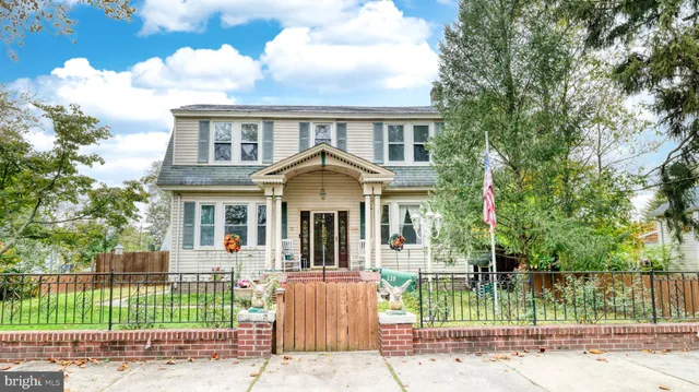 a front view of a house with a garden and plants