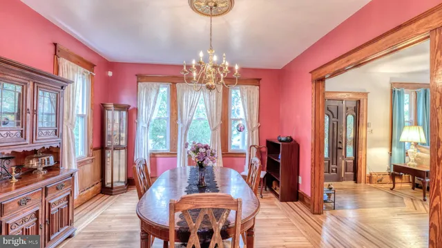 a view of a dining room with furniture window and wooden floor