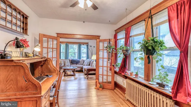 a living room with furniture fireplace and a large window
