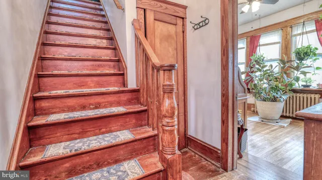 a view of entryway with wooden floor and a front door