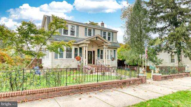 a front view of a house with a garden and plants
