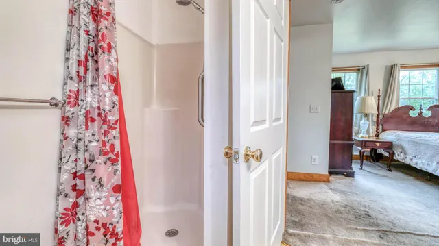 a view of a bedroom with a bed and a couch