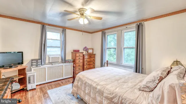 a bedroom with a large bed and a flat tv screen