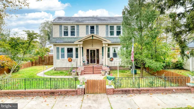 a front view of a house with a garden and yard