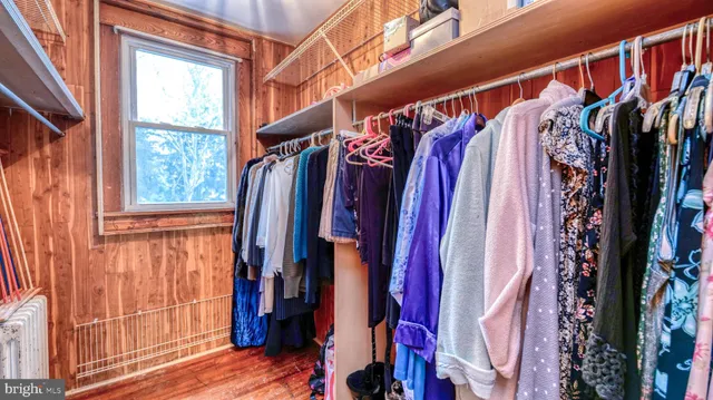 a view of walk in closet with clothes