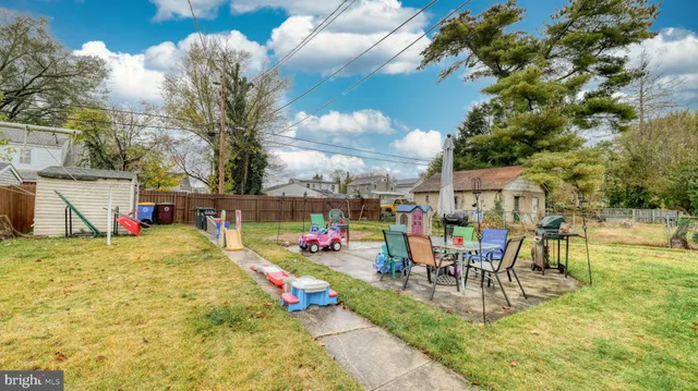 a swimming pool with outdoor seating and yard